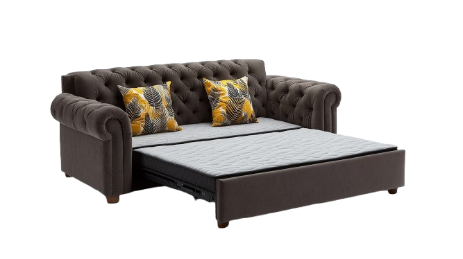 A brown tufted sofa with rolled arms, featuring two yellow decorative cushions with tropical leaf prints. The sofa is pulled out, revealing a mattress for use as a sleeper.