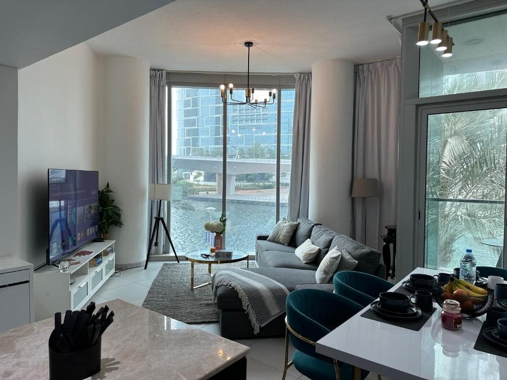 Furnished two-bedroom apartment living room cleaned and organized by professional home deep cleaning services in Dubai, ensuring a comfortable and clean living space.