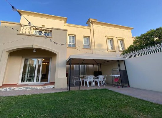 Exterior view of a furnished 2BHK villa with a well-maintained backyard and patio in Dubai, ideal for professional home deep cleaning services.