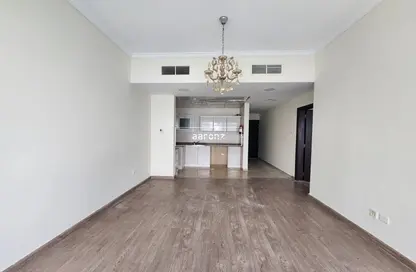 Spacious and open 1BHK unfurnished apartment living area with natural lighting, demonstrating a freshly cleaned and organized space in Dubai.