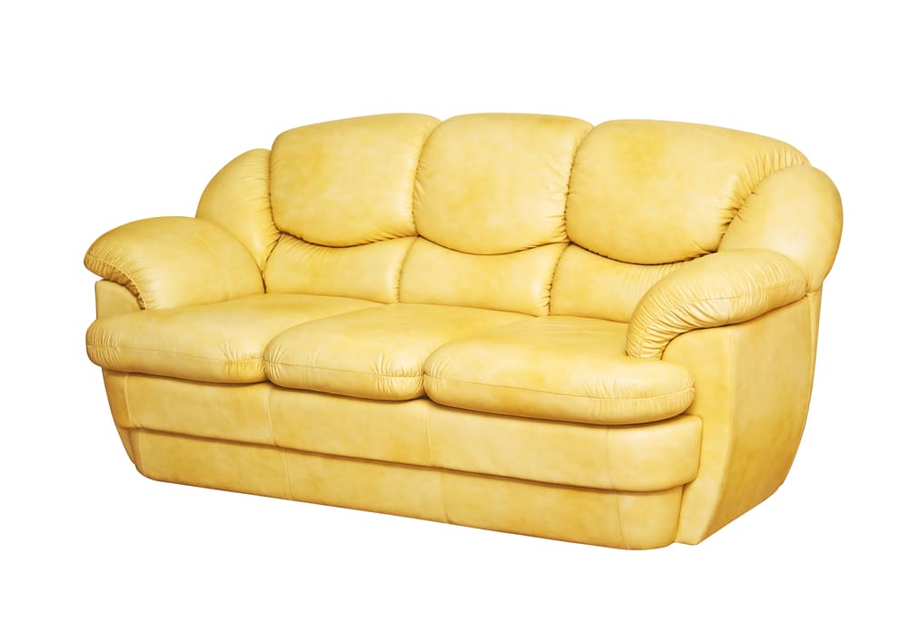 Yellow leather 3-seater sofa cleaning service in Dubai for effective stain removal and deep conditioning.